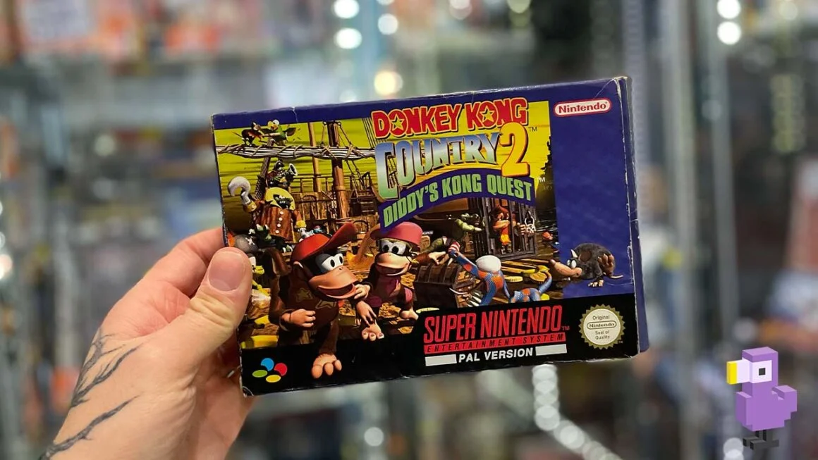 Donkey Kong Country 2 Diddy Kong's Quest game box held by SNES
