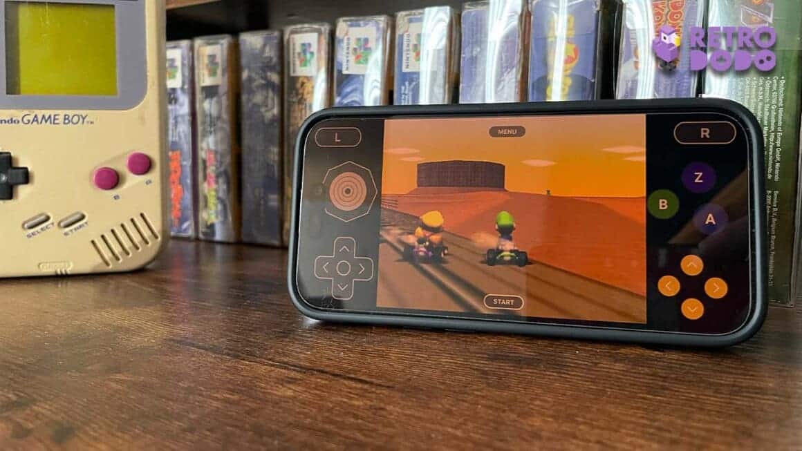 an iPhone playing Mario kart next to a Game Boy DMG and N64 games
