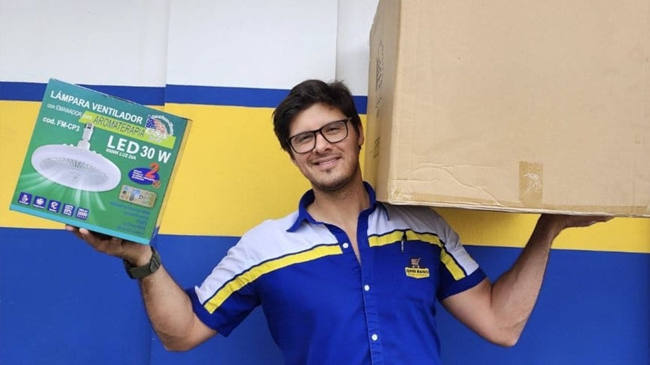 Carlos Alfaro holding boxes outside of the store