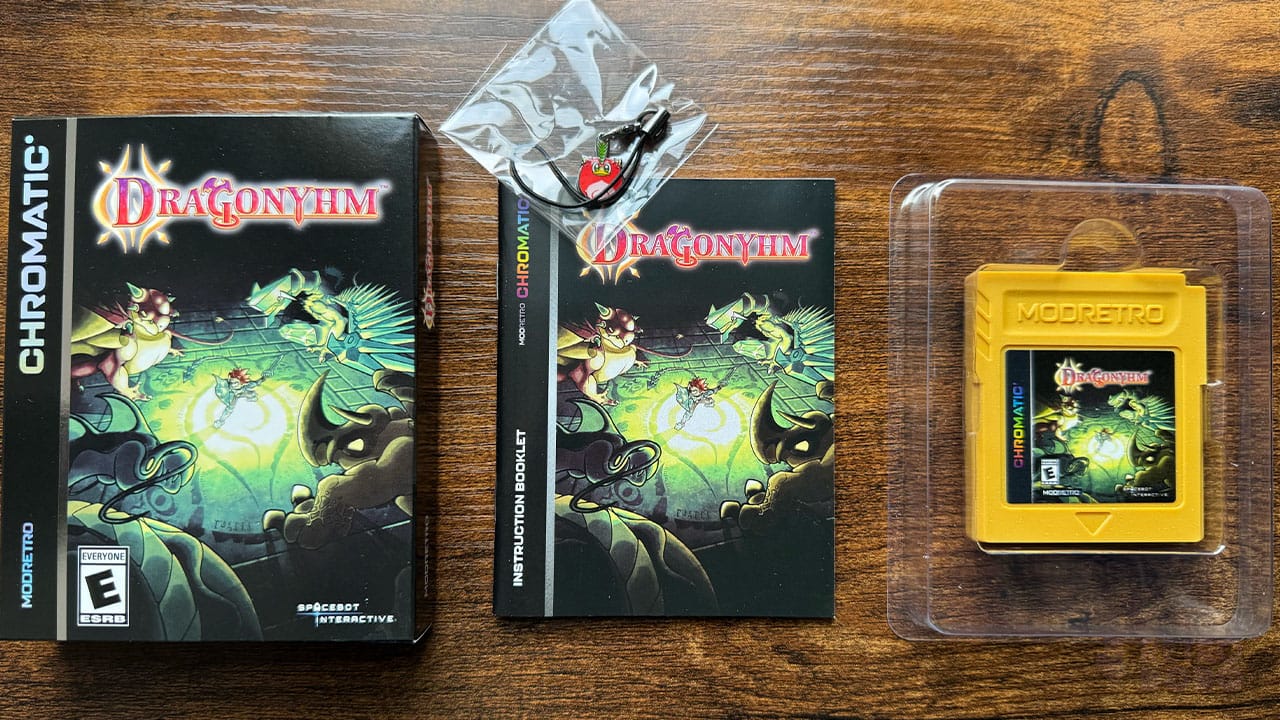 The box, manual, game cartridge, and charm for Dragonyhm