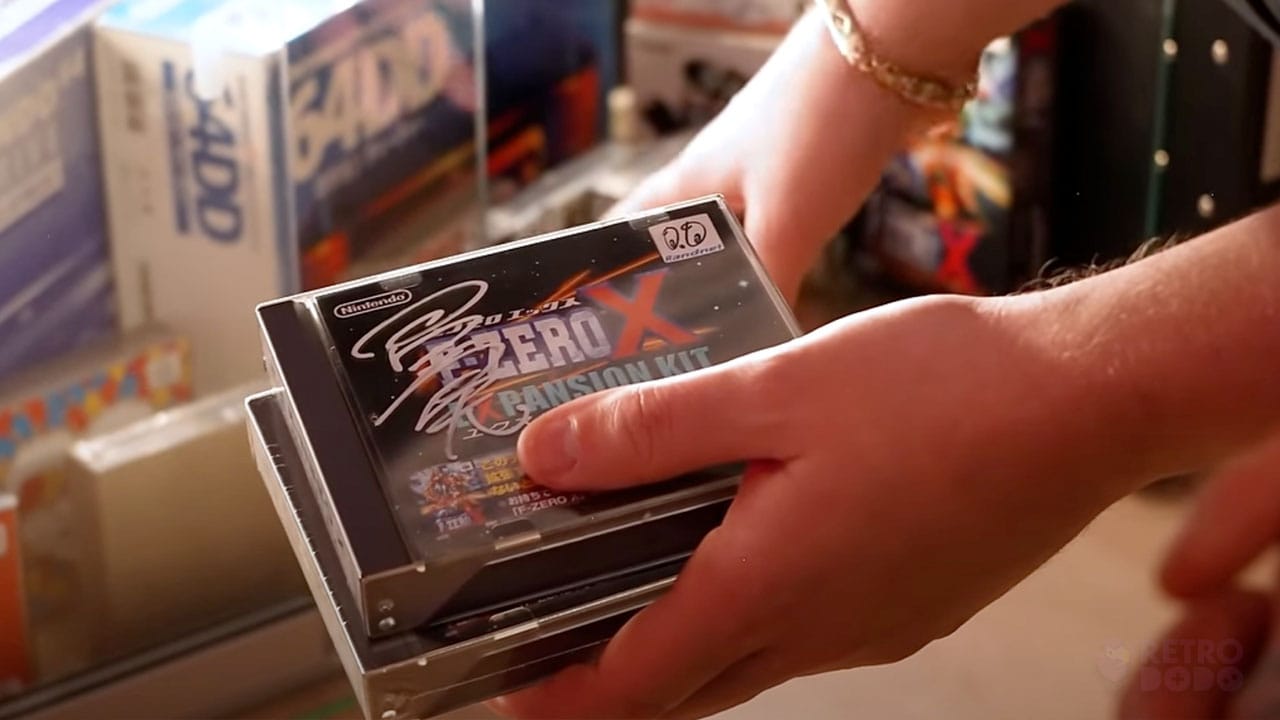 Donny holding a sealed copy of F-Zero X for the 64DD