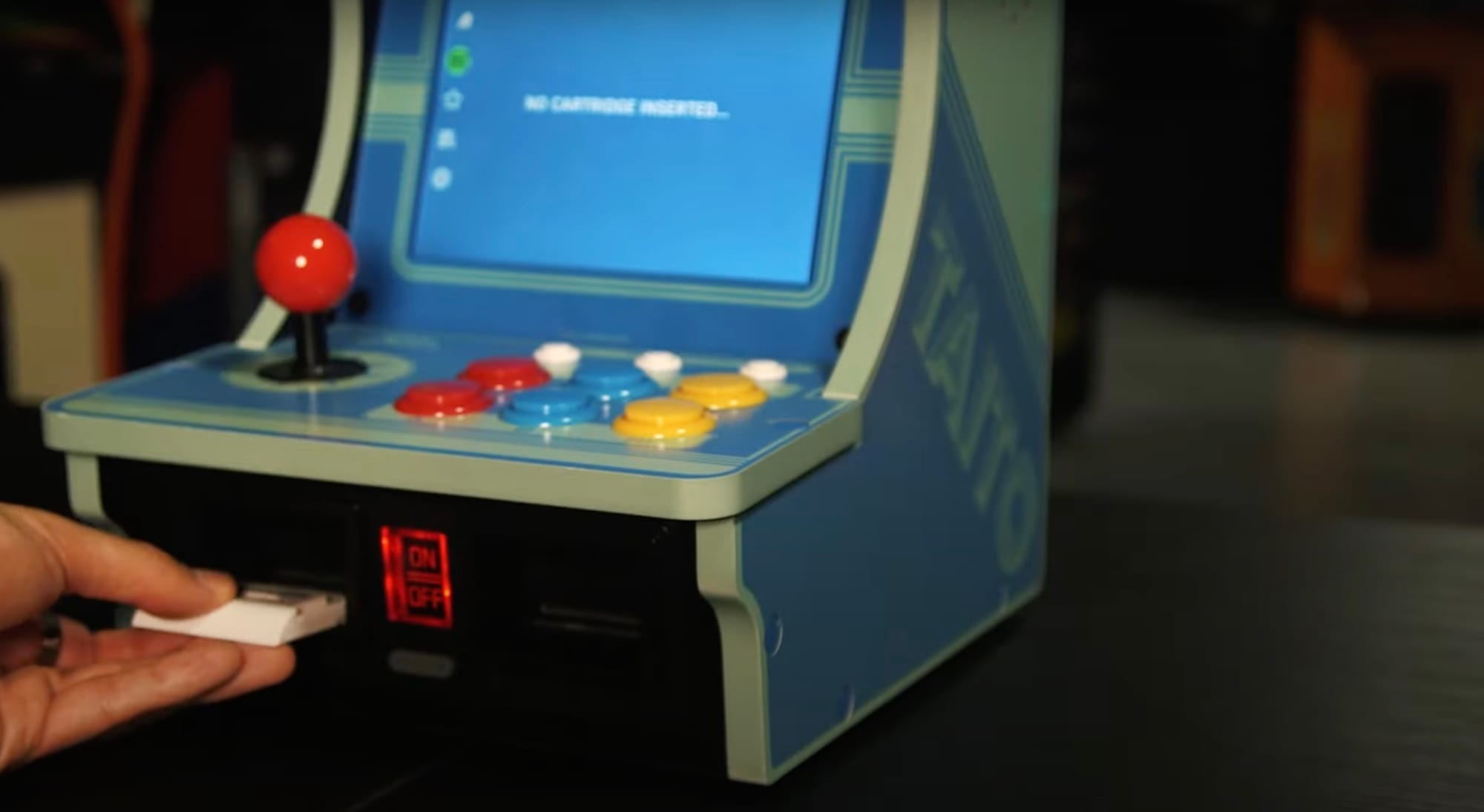 Inserting a cartridge into the Evercade Alpha Bartop Arcade