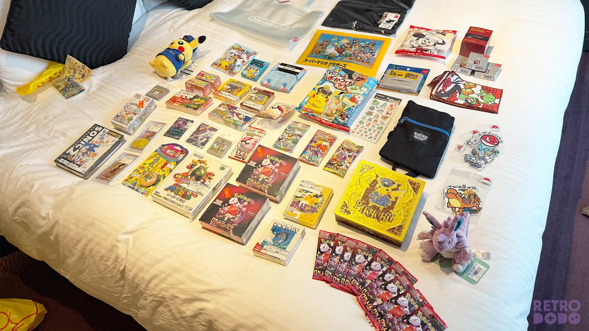 Brandon's haul of retro games and cards spread out on his bed