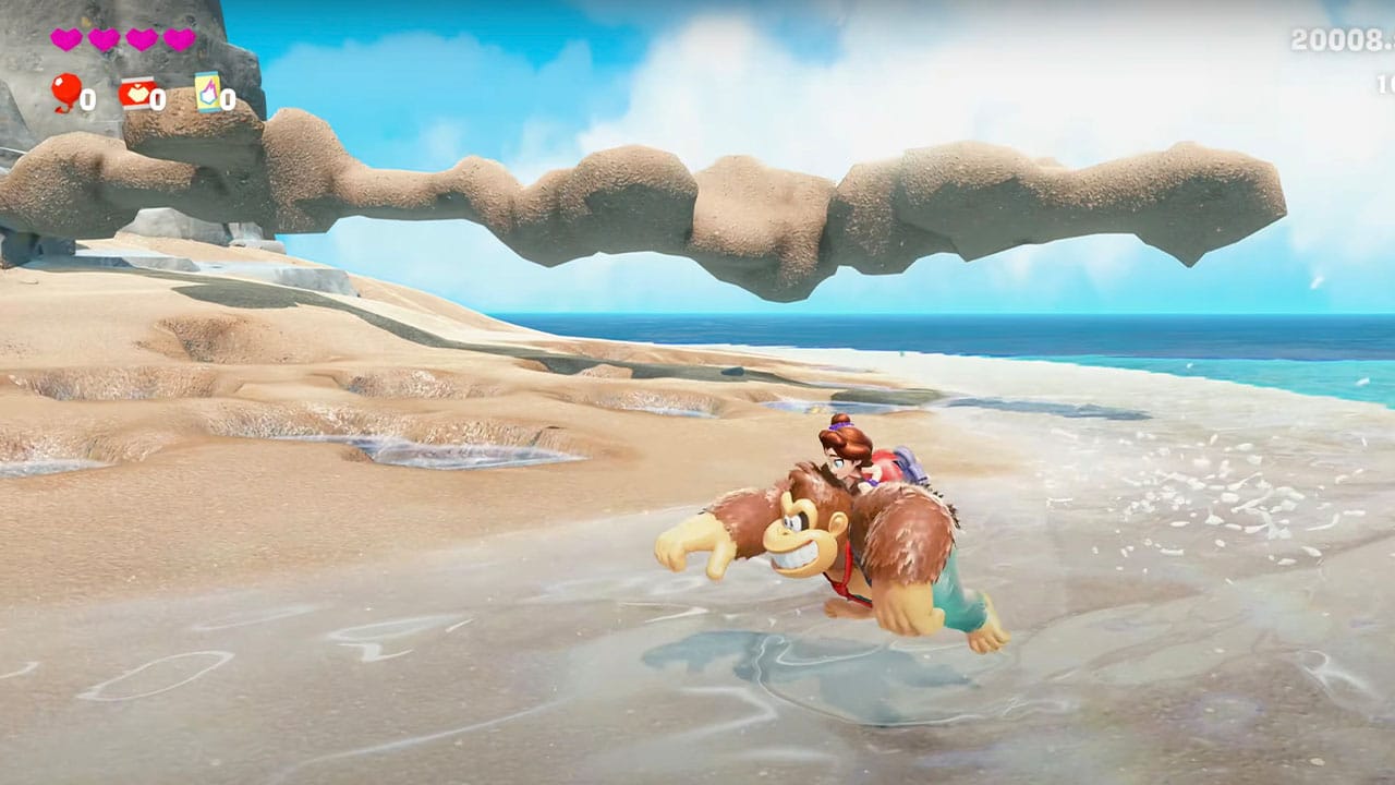 DK running across sand with Pauline on his back