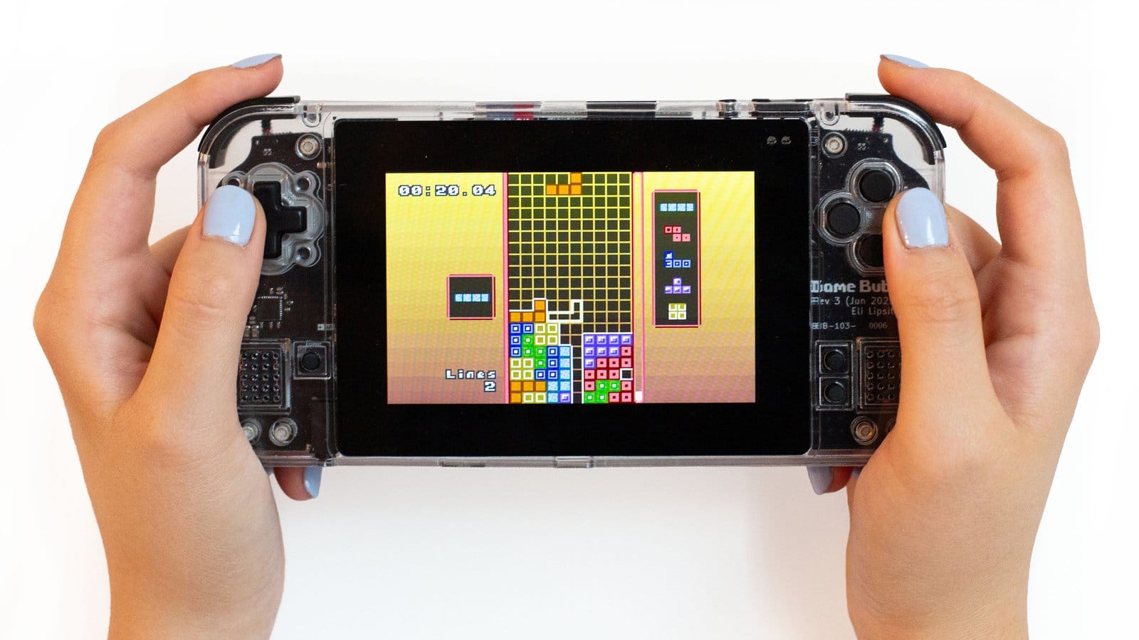 Two hands holding the Game Bub