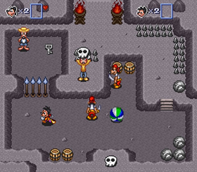 Goofy holding up a skull in a pirate cave while Max avouds pirates