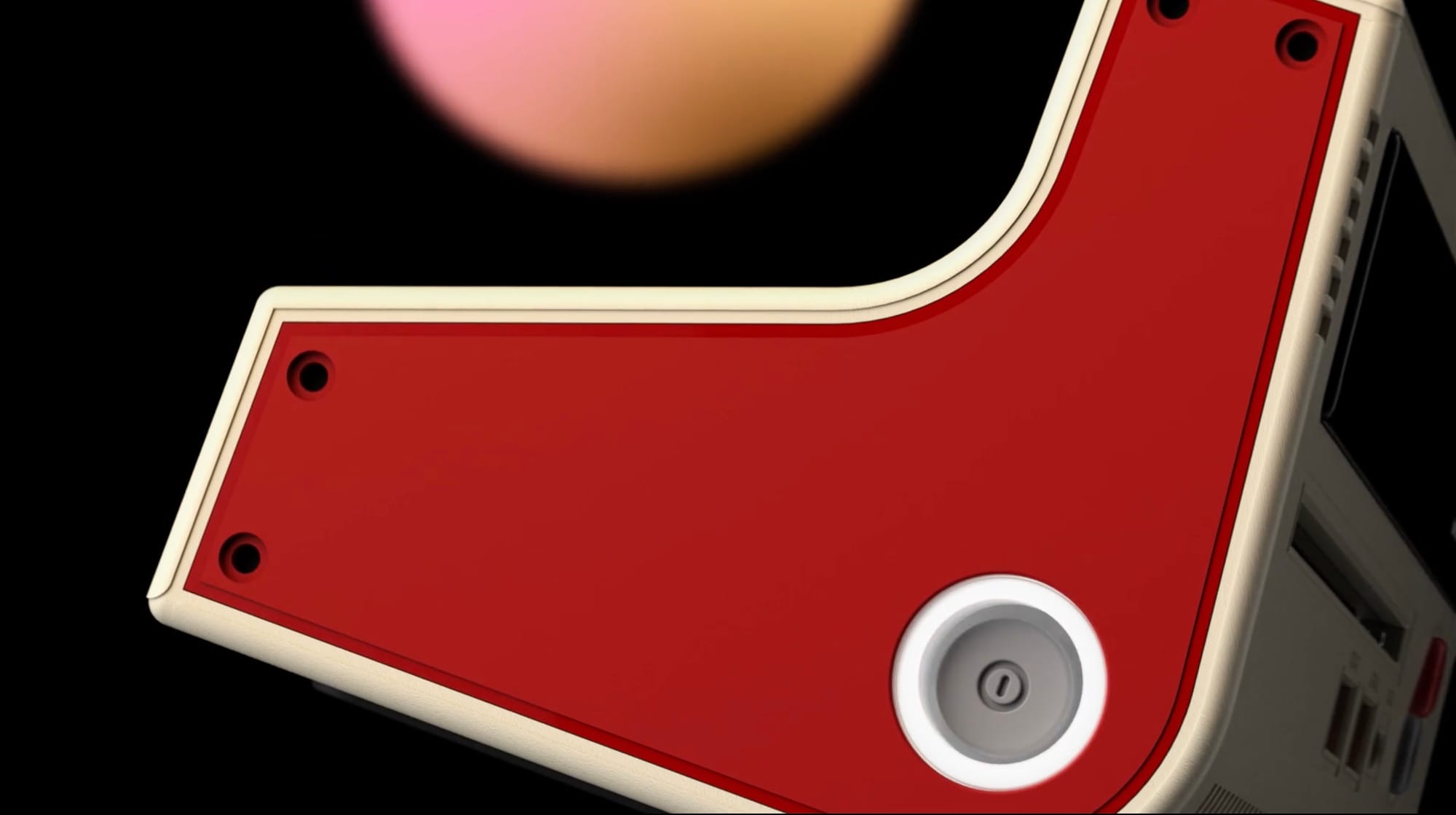 A console-style power button in the red side panel of the TC-02