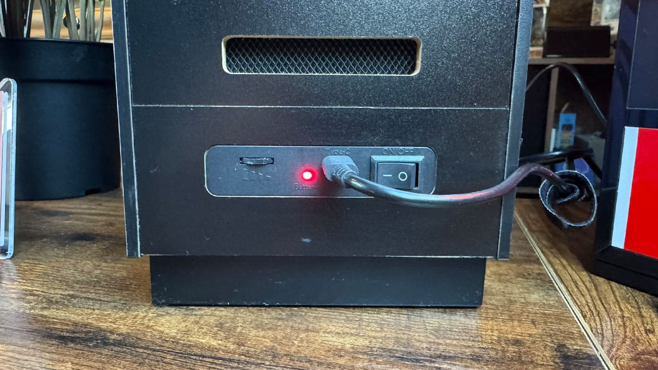 Volume wheel, USB-C Cable, and On/Off button on the back of the miniature arcade cabinet