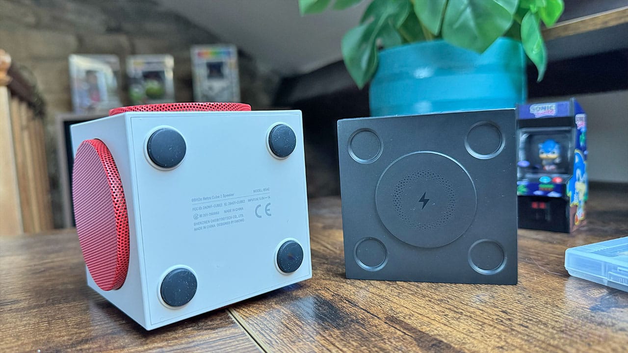 Underside of the Retro Cube 2 Speaker next to its charging dock