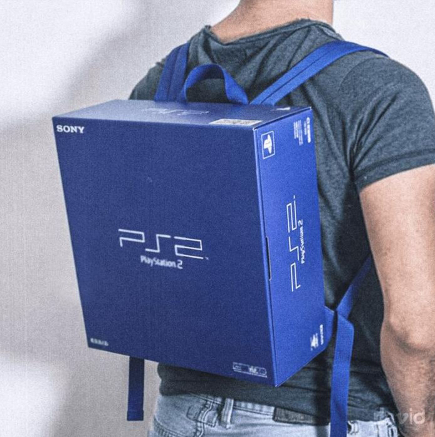 Man wearing a backpack that looks like a PS2 box