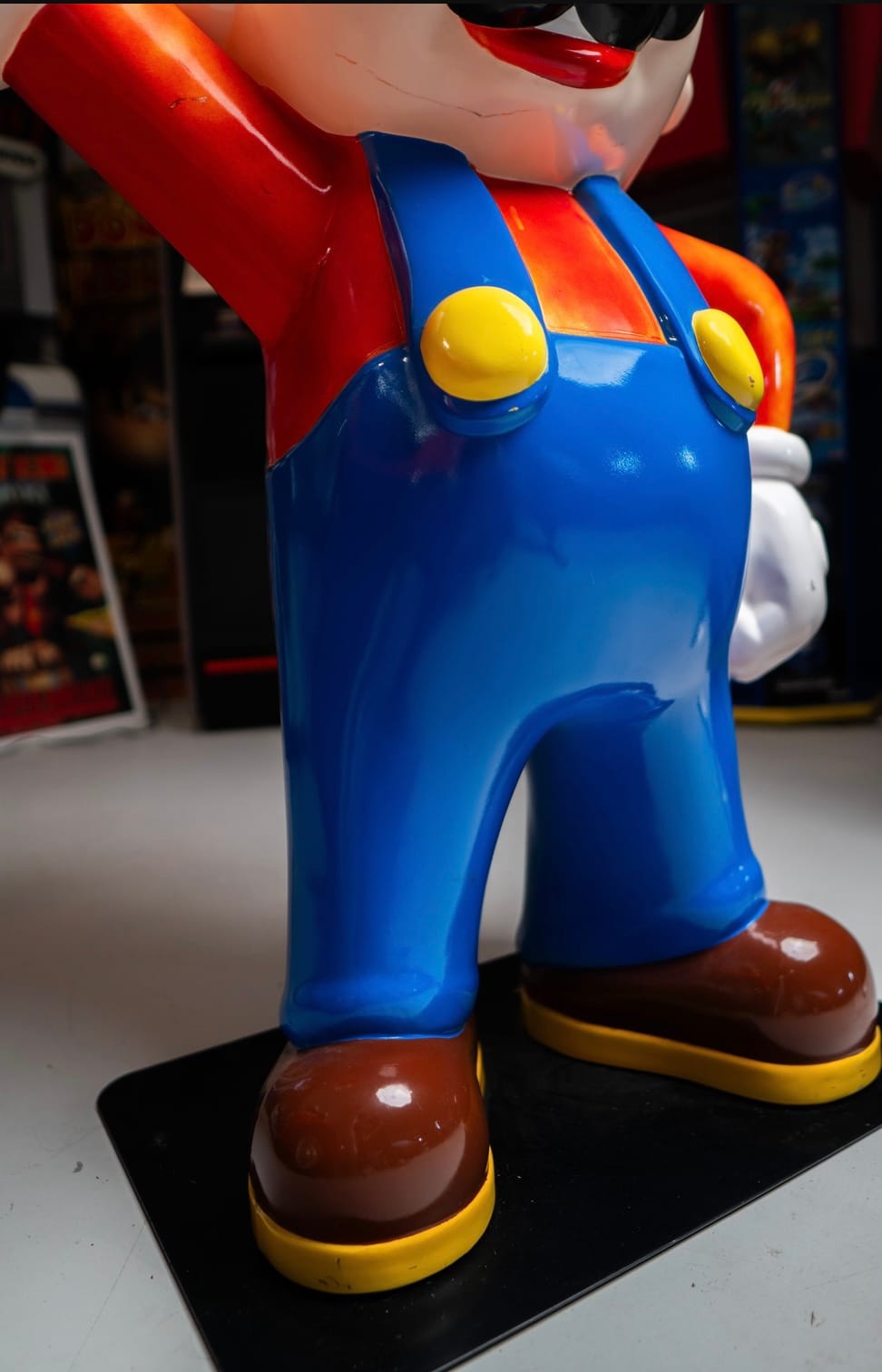 Closer view on the dungarees and buttons on the Insert Bid Mario statue