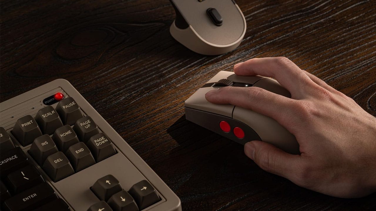 A hand using the Retro R8 Mouse