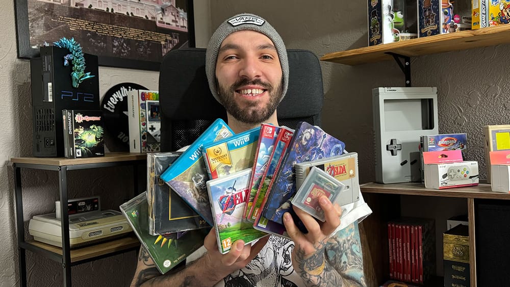 Seb holding all of his Zelda games