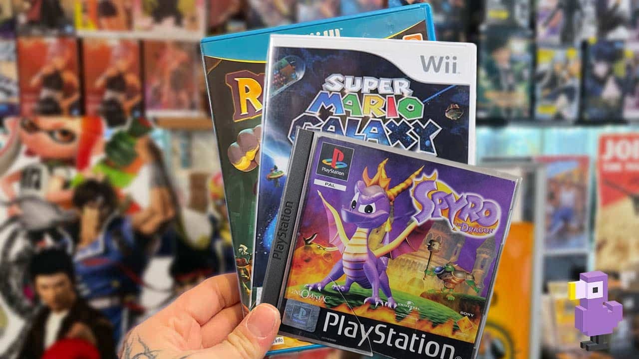 Seb holding video game cases for Rayman, Super Mario Galaxy, and Spyro