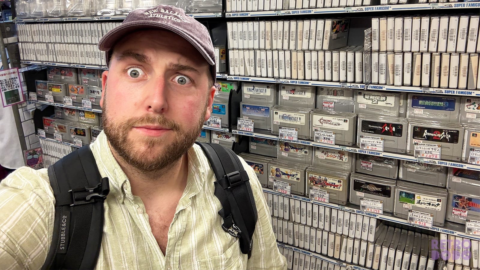 Brandon looking towards a camera with retro games behind him