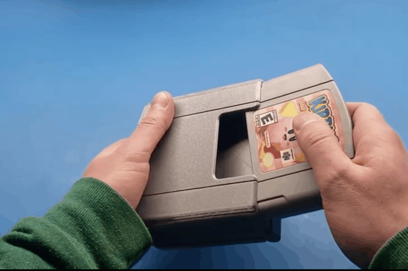 Nintendo 64 Handheld  showing cartridge going into the handheld