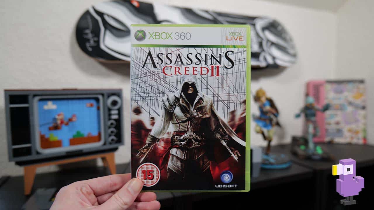 Assassin's Creed II game box in Rob's hand