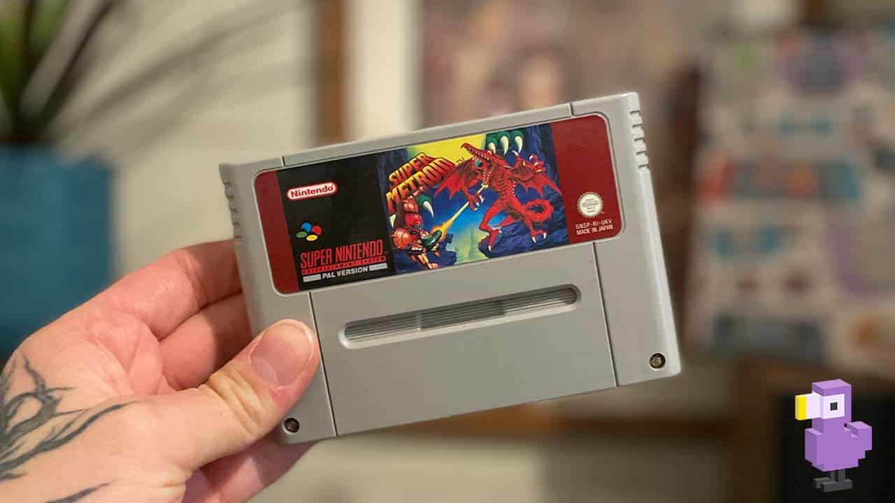 Super Metroid SNES game cart held by Seb