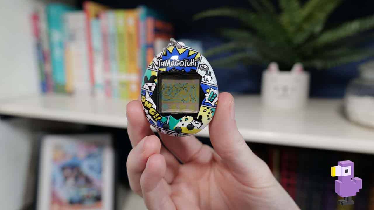 Theo holding up a Tamagotchi