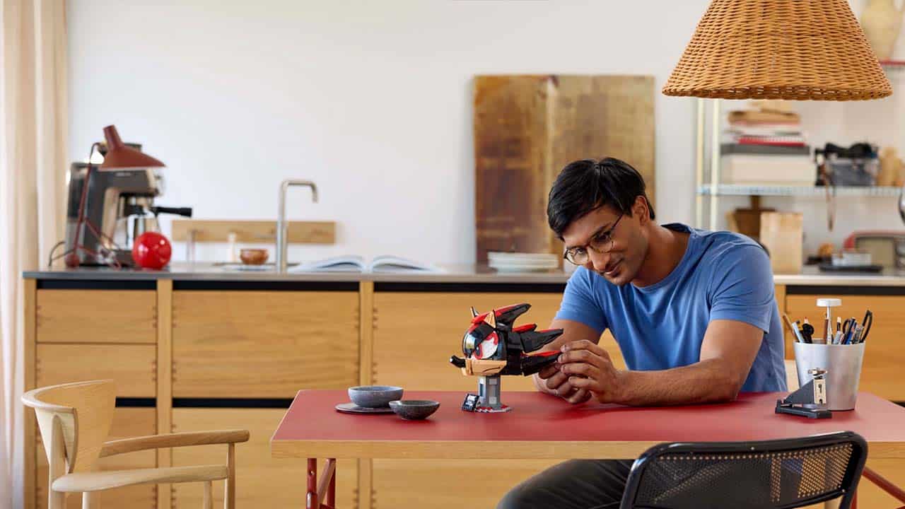 A man building the Shadow Lego Set