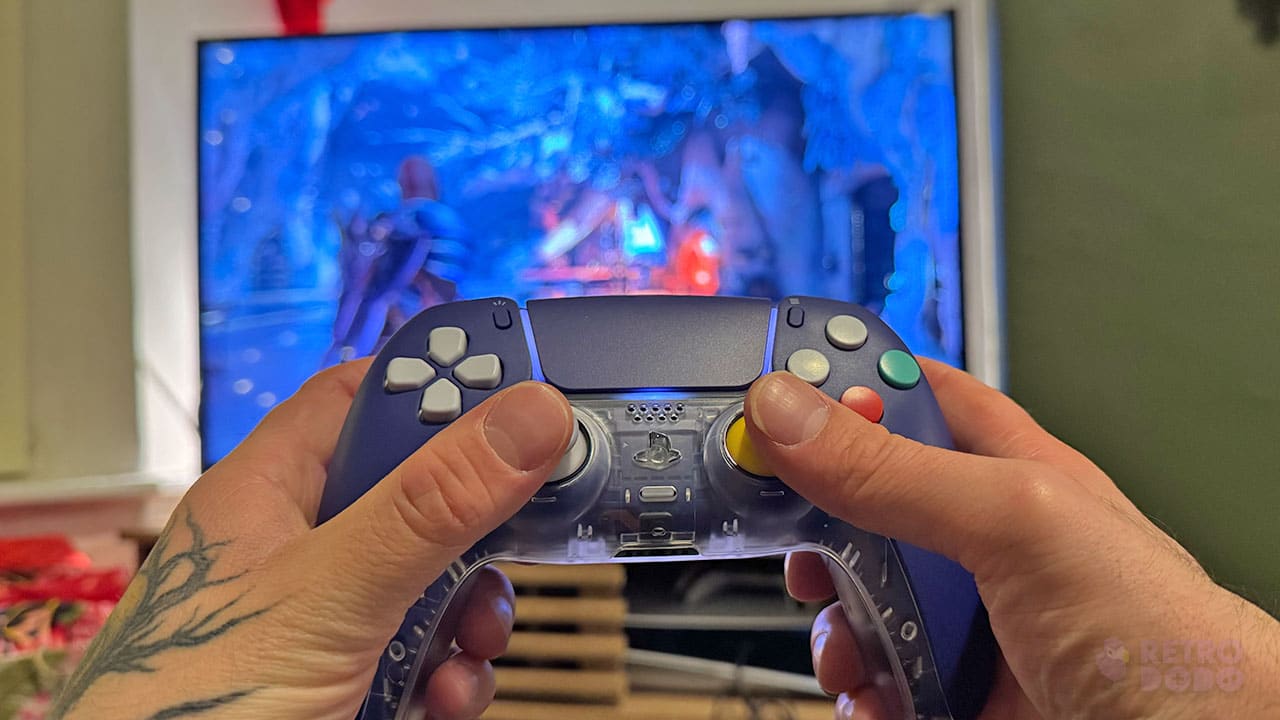 Seb holding his CubeSense controller in front of God of War: Ragnarok