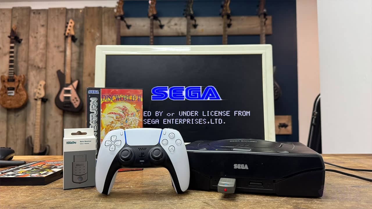 A Sega Saturn with the Retro Receiver plugged in and Sega logo on a TV screen.