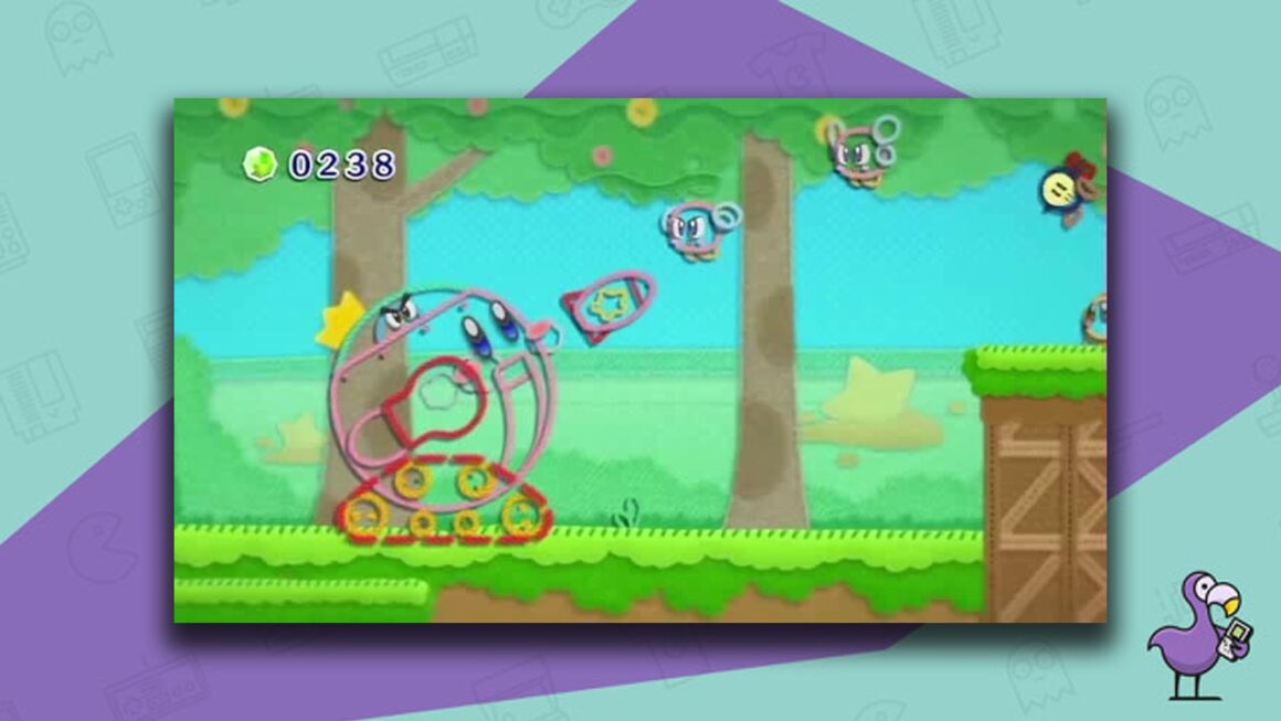 Kirby's Epic Yarn gameplay, with Kirby portraying a tank firing missiles at enemies. 
