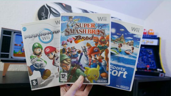 Rob holding a selection of Nintendo Wii games in his games room
