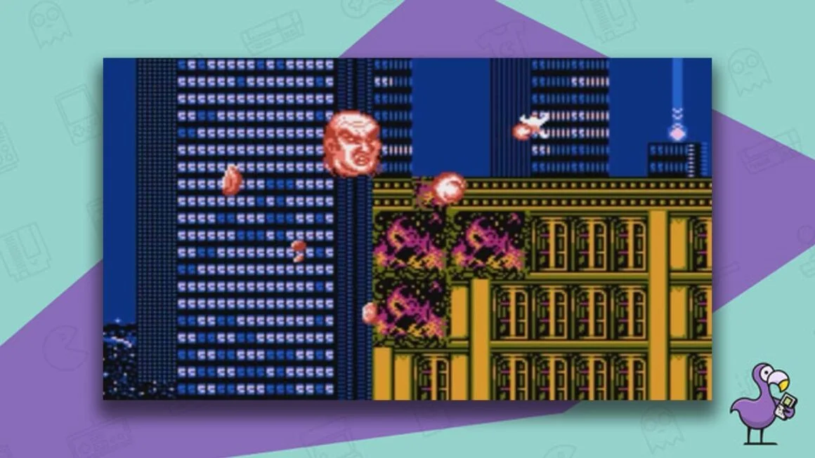 Zombie Nation gameplay, with an orange floating head destroying a building with orange balls