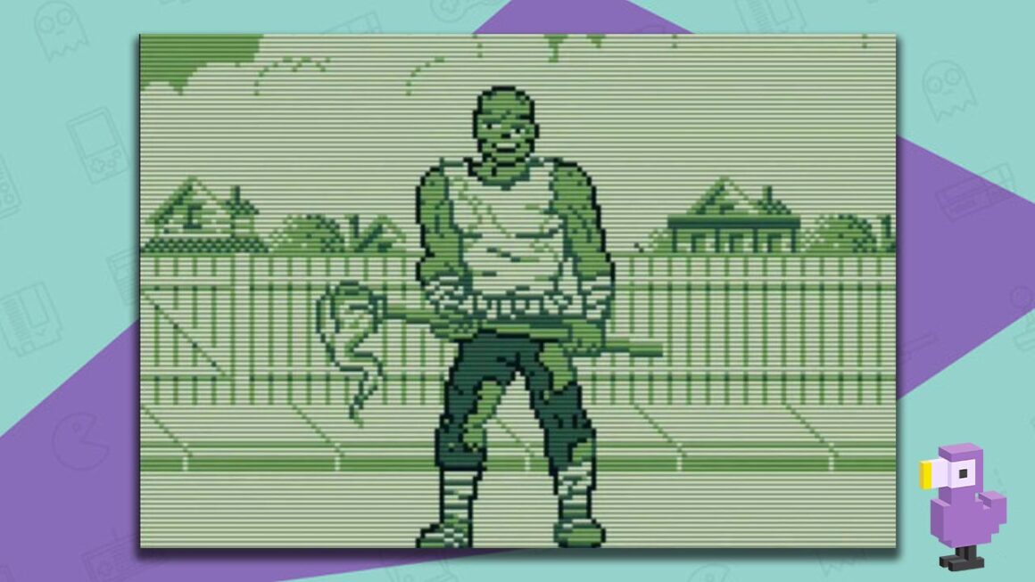 Toxic Crusaders gameplay - Toxie holding a mop in front of a fence on an empty street