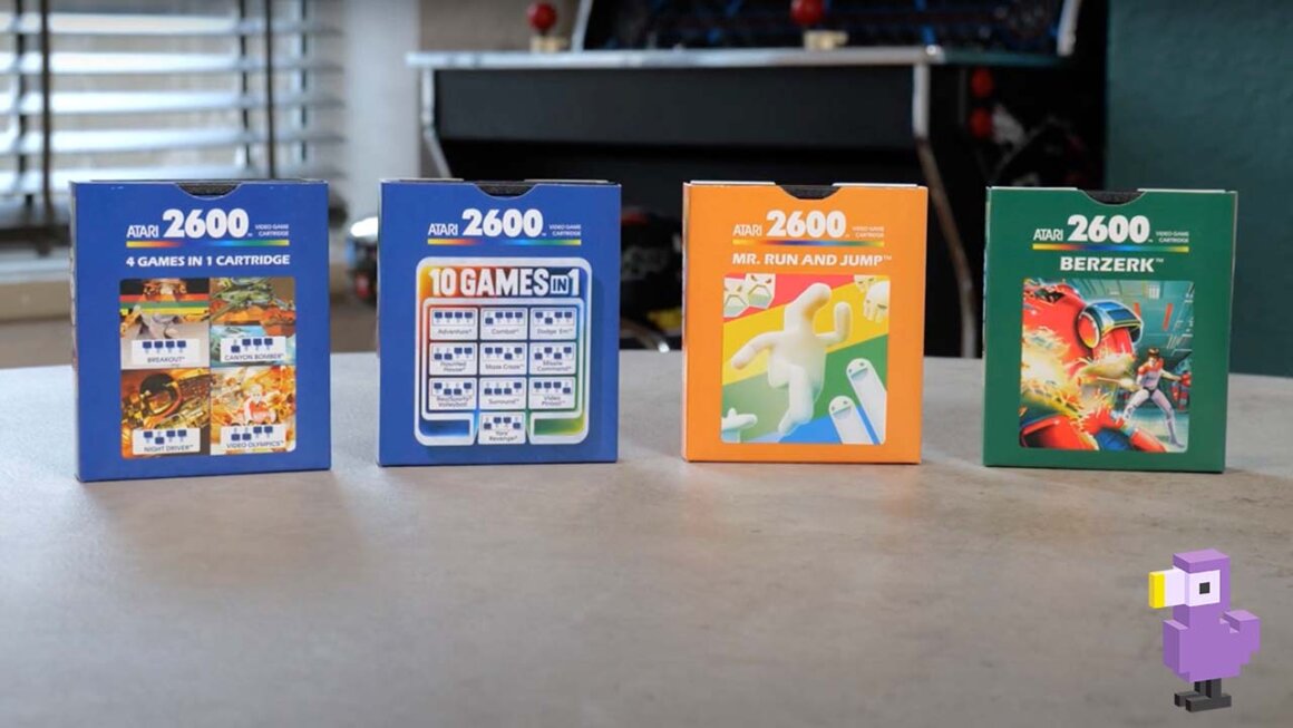 Four Atari 2600 game cartridges in a row on a table top