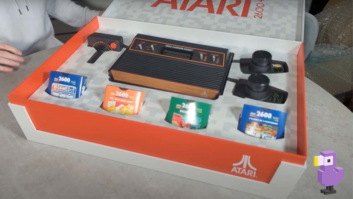 Opening up the Atari 2600+ box, with paddles, joystick, and games