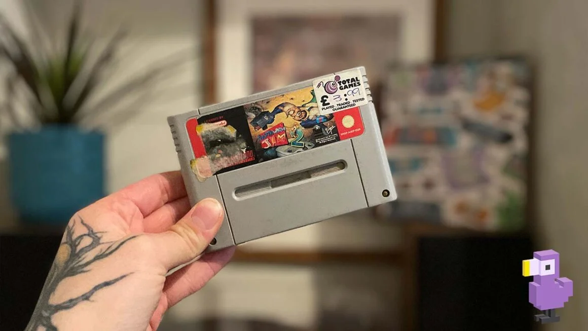 Seb holding Earth Worm Jim 2 cartridge for the SNES