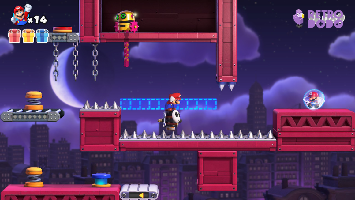 Mario rides a shy guy across some spikes.