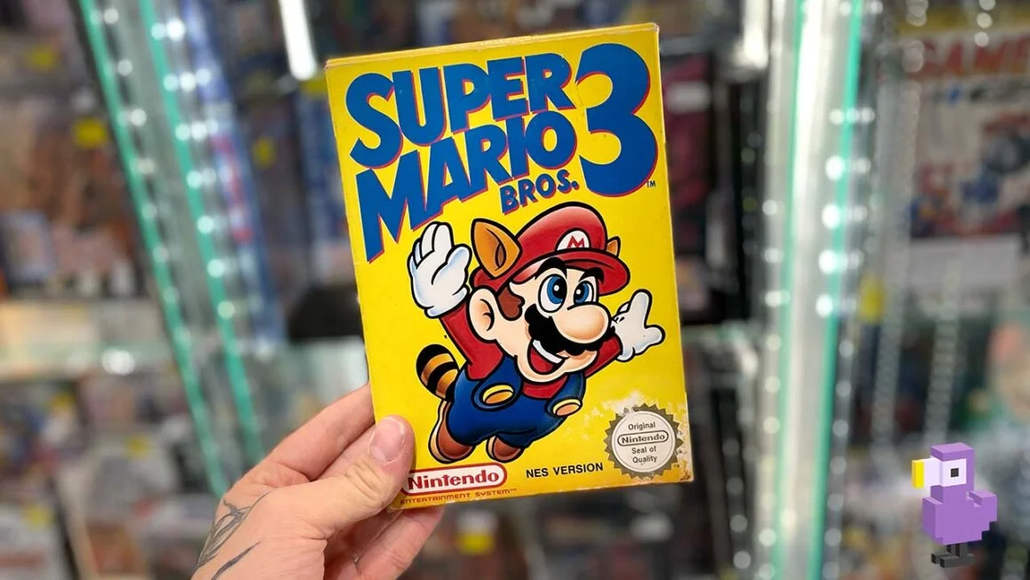 Seb holding Super Mario Bros 3 for the NES