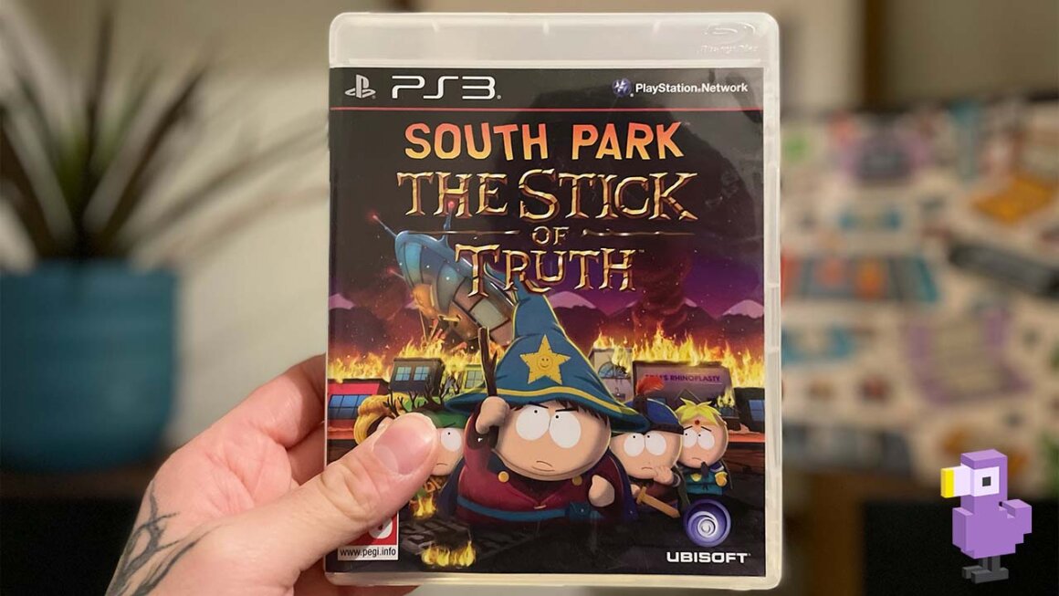 Seb holding up a game case for South Park: The Stick of Truth