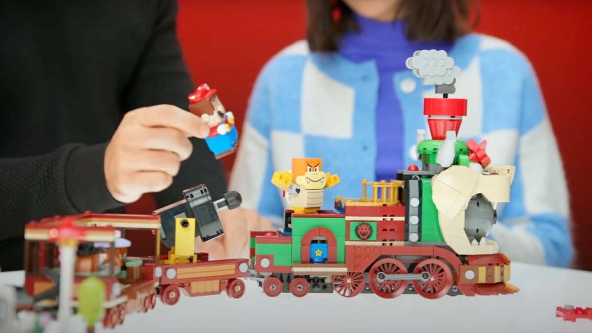 A family playing with Bowser's Express Train LEGO set