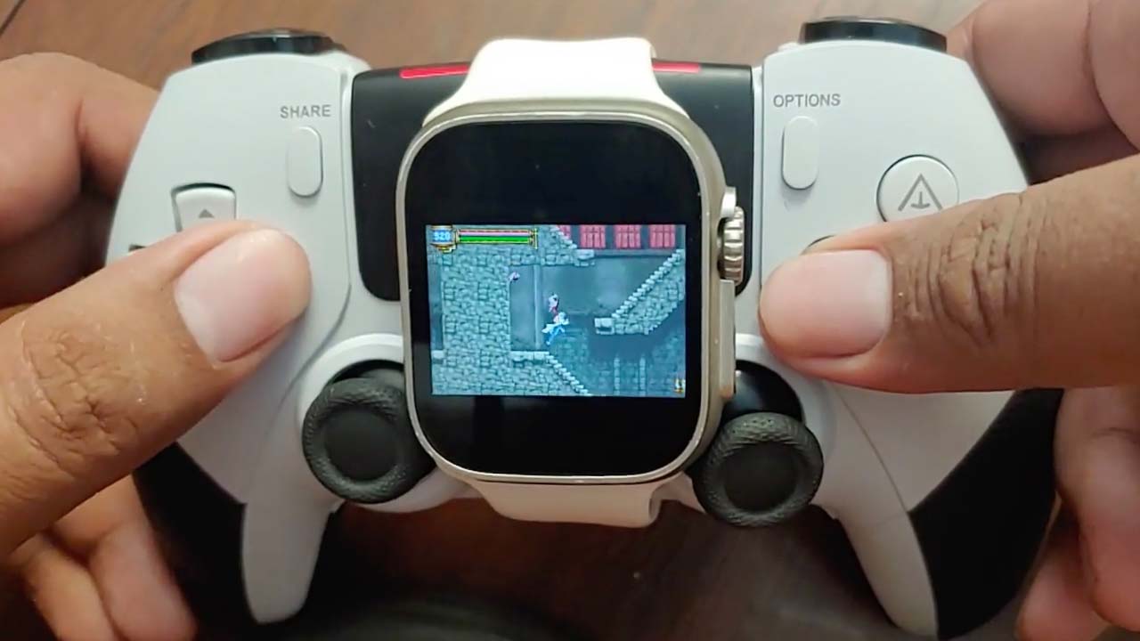 A photo of an apple watch running android on a PS5 controller