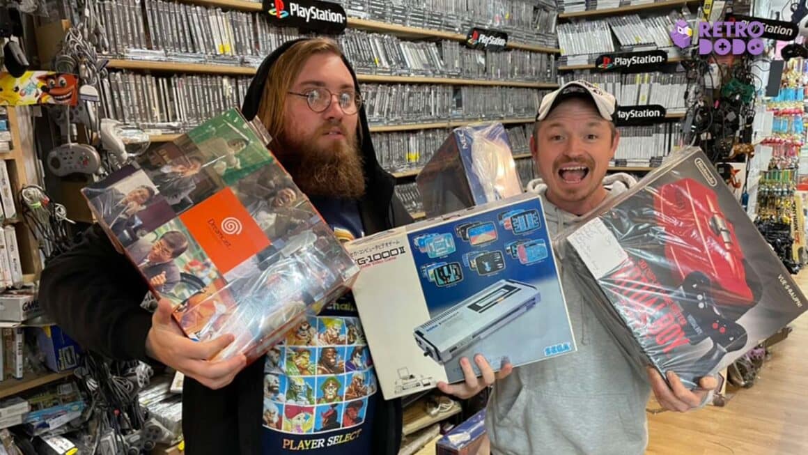 Liam and Lee holding boxed consoles