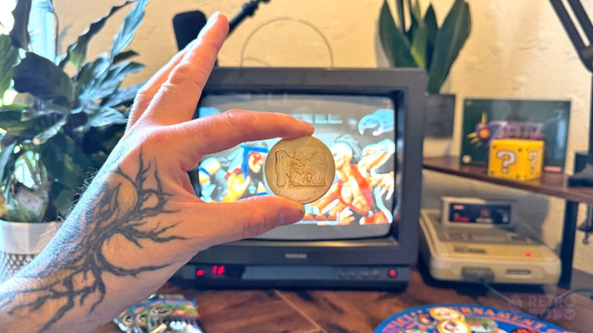 Seb holding his Gold KINI Slammer in front of his CRT TV