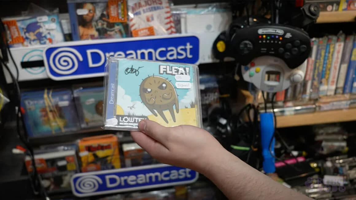 Liam holding a signed copy of the Dreamcast game 'Flea'